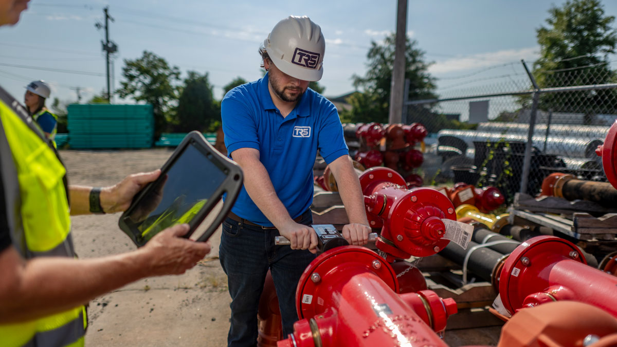 worker doing a safety check on a piece of equipment