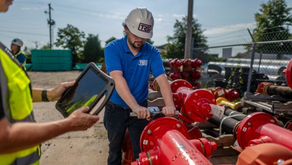 worker doing a safety check on a piece of equipment